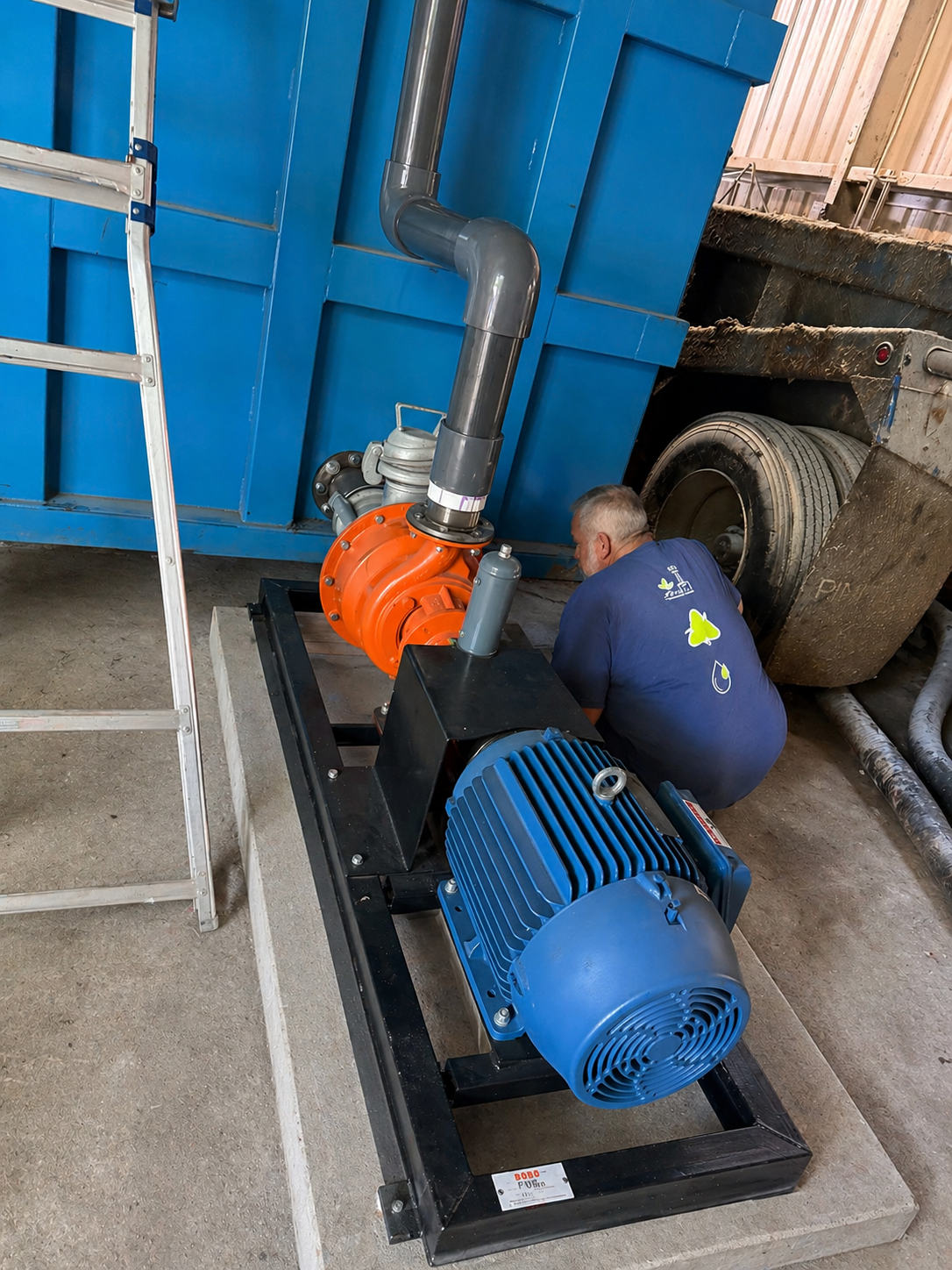 Skid-mounted jet mixing pump and motor assembly tied into an EnviroBox tank for EQ blending