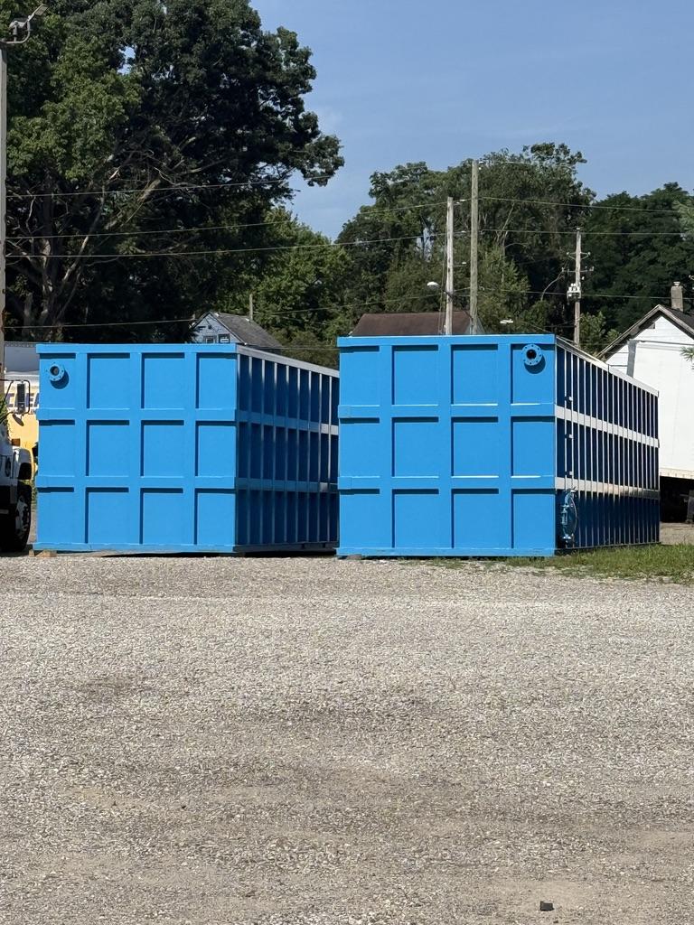 Two open-top blue EnviroBox tanks back to back showing the internal rib walls