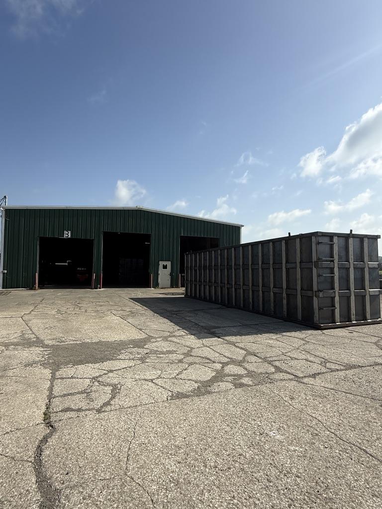 Fabricated steel EnviroBox shell staged outside the shop before coating